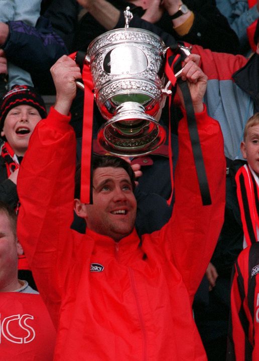 Darren Moore holds up the Gibson Cup after winning the league with Crusaders in 1995